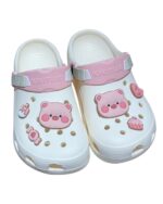 White Piggy Crocs clogs with pig decorations and branding.