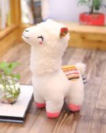 Soft white llama plushie with colorful ears and a striped tail. A cute llama plushie.