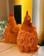 A plush, fat chicken toy (fat chicken plushie) displayed on a table with a reflection.