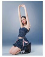 Model wearing a Laced Denim Mini Skirt - Y2K aesthetic skirt, featuring a corset top and ruffled mini skirt.