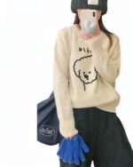 Cream-colored puppy doodle sweater with a cute cartoon dog print.