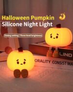 Two Pumpkin Night Silicone Lamps in orange, featuring a cute face and wooden stem details. Product-keyword: pumpkin night light