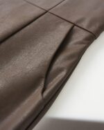 Close-up of vegan leather high waist shorts, vintage aesthetic, showcasing the textured fabric.