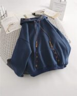 Blue ethno-chic hoodie with embroidered details and tassels on the front pockets.