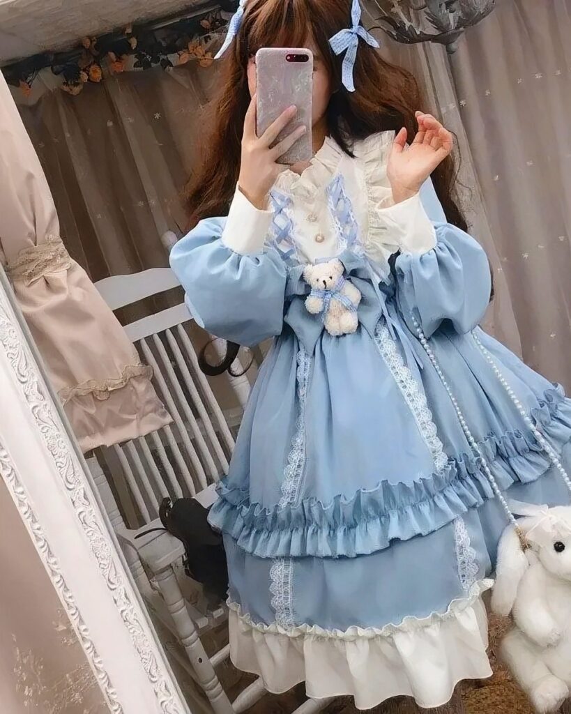 Plus size hime lolita dress featuring a blue layered design with ruffles and lace details.