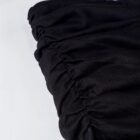 Close-up of a black gothic aesthetic dress with pleating details.