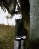 Black gothic aesthetic dress featuring skull print, worn outdoors.