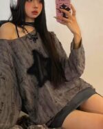 Model wearing a grunge star top, off-shoulder style, with a textured fabric.