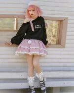 Lolita aesthetic sweater worn by a model, featuring an off-shoulder design and layered skirt.