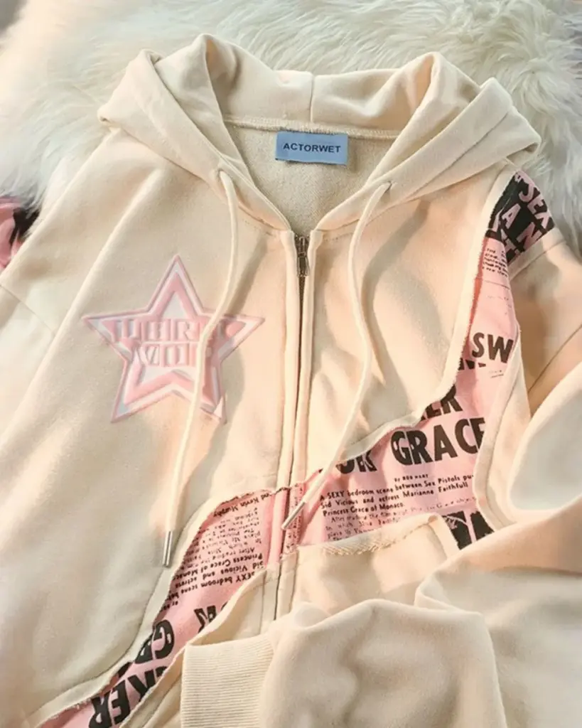 Close-up of a harajuku streetwear hoodie featuring a pink star and printed text.