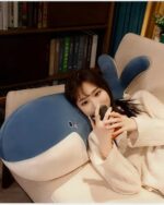 Blue kawaii whale plushie resting on a chair, soft and cuddly.