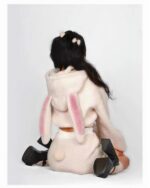 Back view of a person wearing bunny hooded plush pajamas, soft pink fleece.