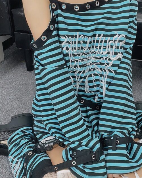 Close-up of a punk lolita set featuring a striped top with embroidery and black lace stockings.