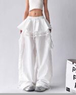 White y2k cargo pants with lace details and a voluminous, layered design.