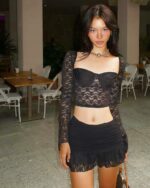Black lace coquette aesthetic set featuring a long-sleeved crop top and mini skirt.
