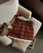 Red plaid mini skirt with white trim, showcasing a preppy aesthetic.