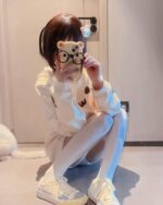 Person wearing a white kaomoji bear hoodie and glasses. Kawaii clothes.