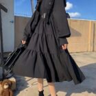 Cute Dark Dress - Gothic Lolita Aesthetic, a long-sleeved, tiered black dress with a belt and boots.