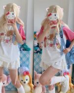 Person wearing a harajuku aesthetic shirt with Hello Kitty print, pink accessories, and plush toys.