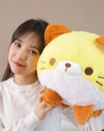 Kawaii Neko Cat Round Pillow, a plushie with yellow and brown fur, held by a person.