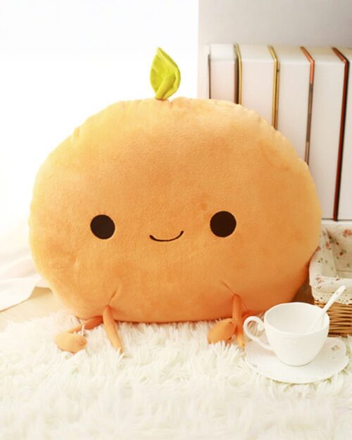 A plush orange kawaii fruit plushie with a smiling face and leafy stem.
