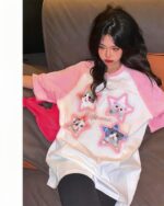 Kitty pink t-shirt featuring cute cat illustrations on a pink and white print.