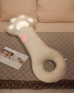 Cute Super Soft Cat Paw Sleeping Pillow resting on a patterned rug.