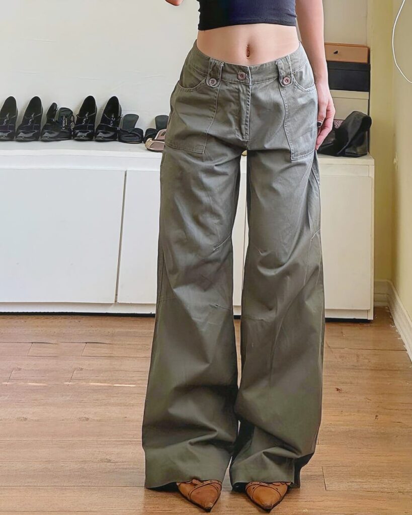 Olive green y2k aesthetic pants, wide-leg style, standing on floor.