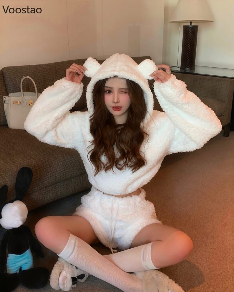 Model wearing white bear pajamas with hood and matching socks. Cute kawaii clothes.