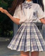 A pleated jk plaid skirt in a gray and white checkered pattern, part of a kawaii school outfit.