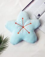 Blue cherry blossom pillow with orange accents, kawaii decor style.