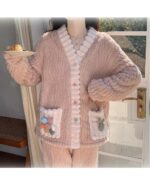 Pink kawaii plush pajamas set with fluffy details and button closures.