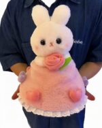 Close-up of a white and pink bouquet rabbit plushie with rose details, a cute gift.