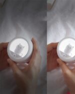 Person holding a kawaii cat lamp, body-activated night light.