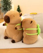 Two plush capybara figures, one wearing a green turtle backpack, from the Cabypara Turtle Collection.