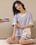 Woman wearing kawaii bear pajamas, light purple loungewear set.