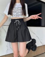 Black elastic korean aesthetic shorts with drawstring detail.