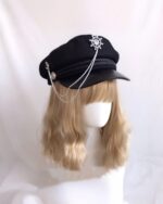 Black gothic style army hat with a chain and decorative wheel pin, Lolita aesthetic.