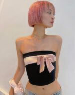 Black bow crop top, a coquette aesthetic top, features a strapless design and large bow detail.