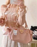 Off Shoulder Sweater - Himekaji Aesthetic in light pink, featuring ruffles and a gold accessory.