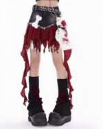 Detailed punk plaid denim skirt with layered ruffles and a belt.