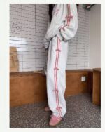 A gray sweatshirt and pink joggers, a korean aesthetic set, with pink ribbon ties.