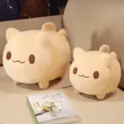 Two soft, light-tan round neko plushies displayed on a table.