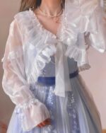 A white fairycore sleeve bow attached to a sheer blouse, Kawaii Clothes.