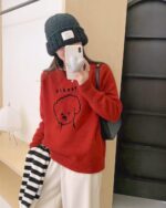 Red puppy doodle sweater with a cute dog graphic on a casual knit top.