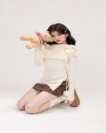Off-shoulder long-sleeved kawaii aesthetic sweater with a teddy bear.