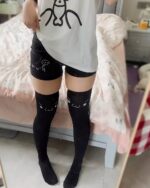 Cute Cotton Black Shorts - Kaomoji Aesthetic, black shorts with cat face design, knee-high socks.