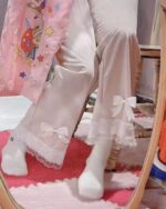 Pink kawaii laced pants with lace trim and a playful print.