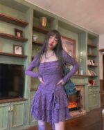 Purple lace gothic aesthetic dress worn by a model in a living room setting.