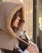 Close-up of a brown korean balaclava hat with fluffy trim, worn by a person.
